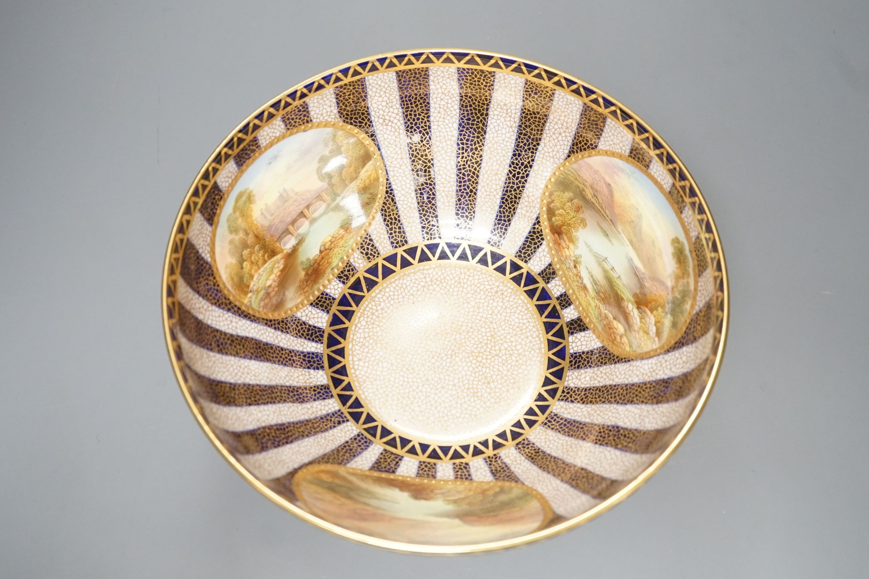 An Aynsley fine bowl with three interior landscape panels and three exterior panels painted with birds between alternating blue and white gilt stripes four panels signed R.J.K. for Richard J. Keeling, c.1910, height 10.5